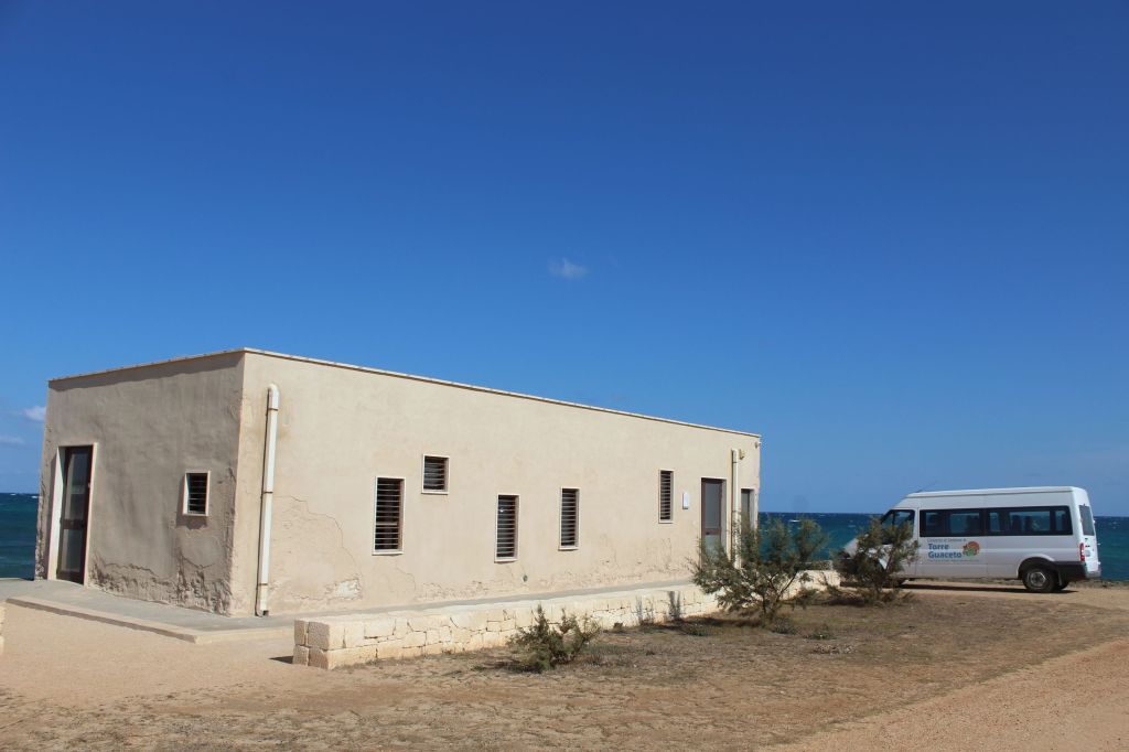 Das Foto zeigt die Schildkrötenauffangstation des Naturschutzgebietes von Torre Guaceto in Apulien vor einem blauen Himmel.